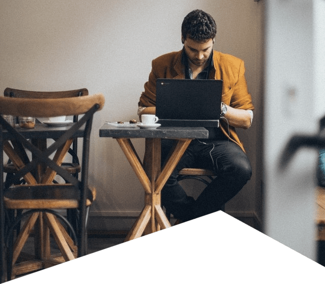 Business man in a cafe searches for professional marketing services on Google